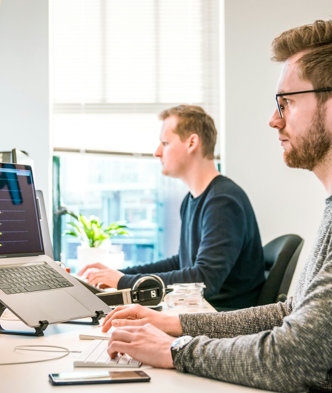 Two Dotinker developers working through code together on screen